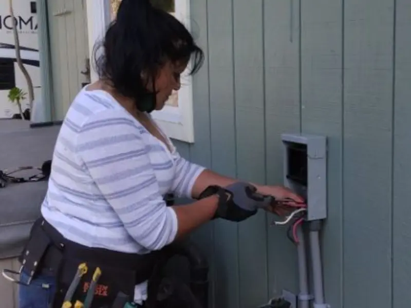 Licensed electrician wiring an exterior subpanel in Dallas